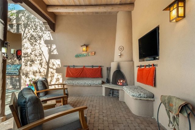 1050 Sierra Del Norte, Santa Fe, NM 87501 - view of patio / terrace with a lit fireplace