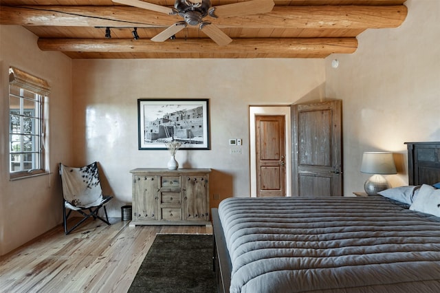 1050 Sierra Del Norte, Santa Fe, NM 87501 - bedroom with wooden ceiling with exposed beams and light wood-type flooring
