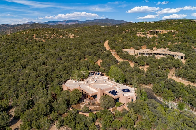 1050 Sierra Del Norte, Santa Fe, NM 87501 - aerial view of property and surrounding area featuring a heavily wooded area and mountains