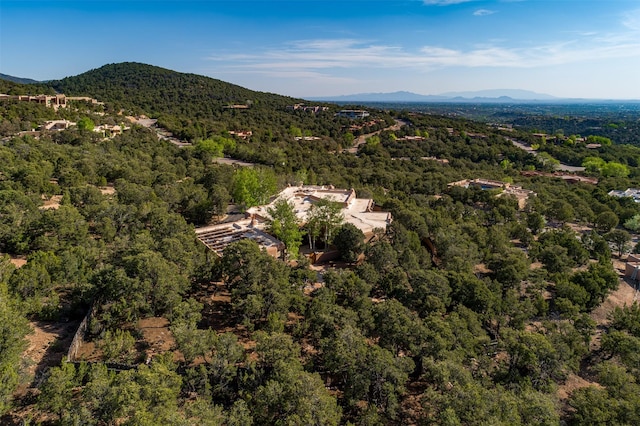 1050 Sierra Del Norte, Santa Fe, NM 87501 - aerial view of property and surrounding area featuring a heavily wooded area and a mountain backdrop