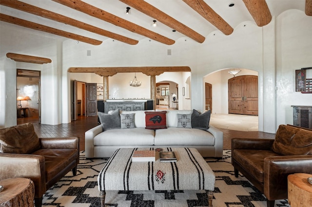 1050 Sierra Del Norte, Santa Fe, NM 87501 - living area with arched walkways, beam ceiling, and a towering ceiling
