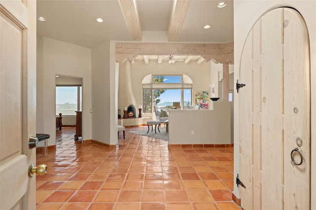 28 Camino Caballos, Lamy, NM 87540 - entrance foyer with beamed ceiling, recessed lighting, a ceiling fan, light tile patterned flooring, and baseboards