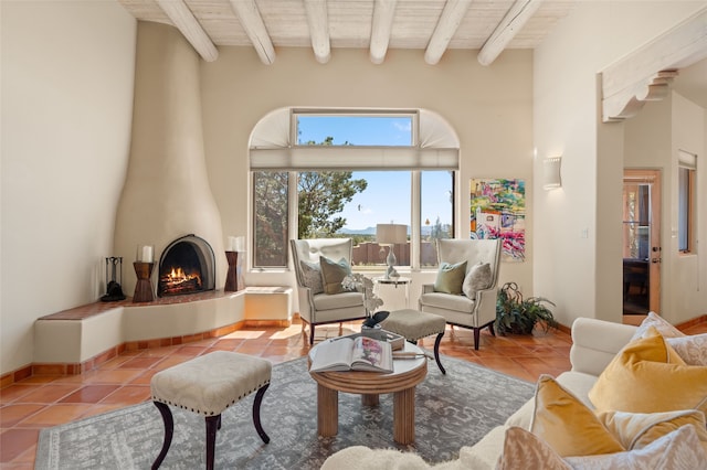 28 Camino Caballos, Lamy, NM 87540 - living area with tile patterned flooring, a fireplace, and wooden ceiling with exposed beams