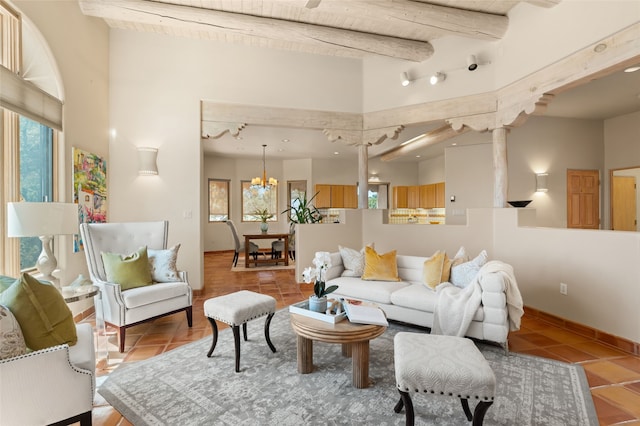 28 Camino Caballos, Lamy, NM 87540 - tiled living area featuring wood ceiling with exposed beams and a chandelier
