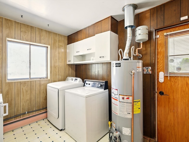 707 Middle San Pedro Rd, Espanola, NM 87532 - laundry area featuring cabinet space, gas water heater, washer and dryer, plenty of natural light, and wood walls