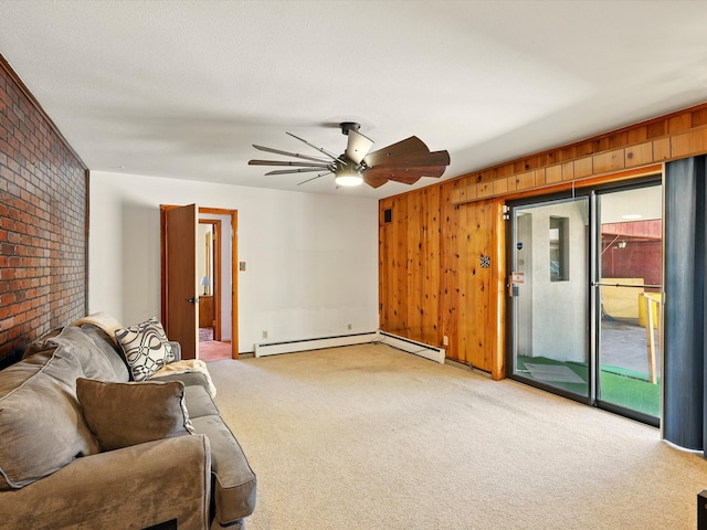 707 Middle San Pedro Rd, Espanola, NM 87532 - living area featuring light carpet, brick wall, ceiling fan, a baseboard heating unit, and wooden walls