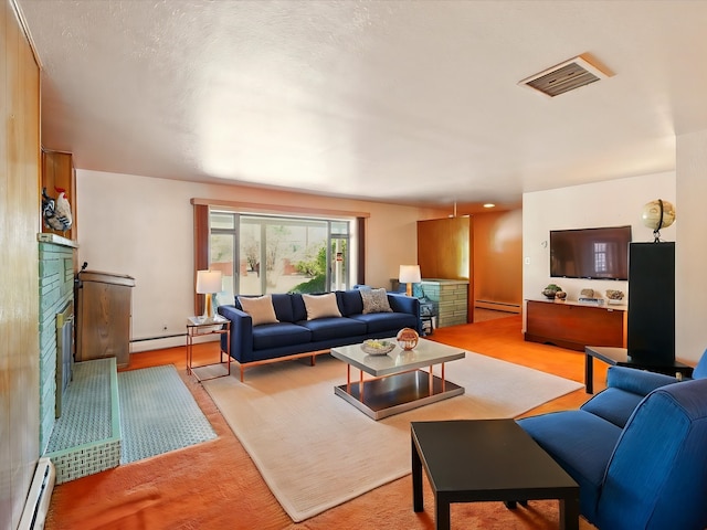 707 Middle San Pedro Rd, Espanola, NM 87532 - living room featuring a fireplace, a baseboard radiator, and light wood-type flooring
