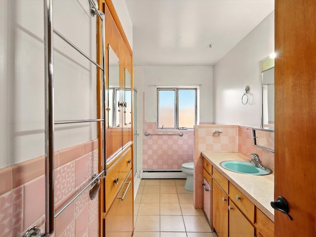 707 Middle San Pedro Rd, Espanola, NM 87532 - bathroom with a baseboard radiator, toilet, tile patterned flooring, vanity, and an enclosed shower