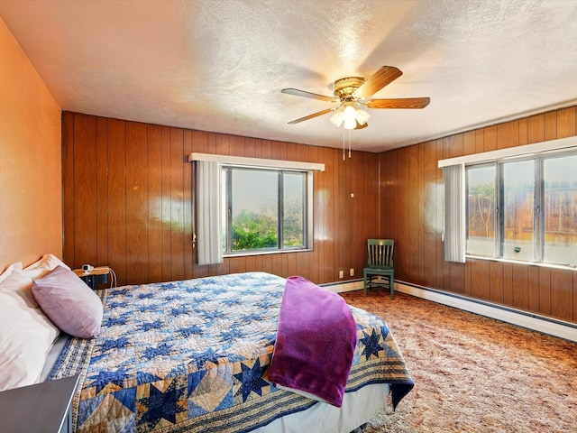 707 Middle San Pedro Rd, Espanola, NM 87532 - carpeted bedroom featuring multiple windows, wood walls, and ceiling fan