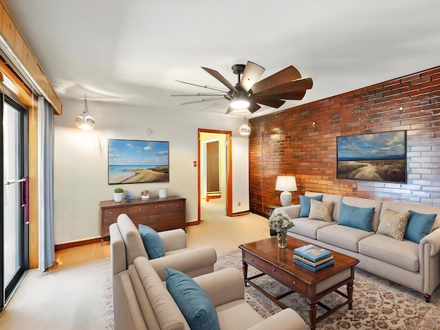 707 Middle San Pedro Rd, Espanola, NM 87532 - living area featuring a ceiling fan, baseboards, brick wall, and light colored carpet
