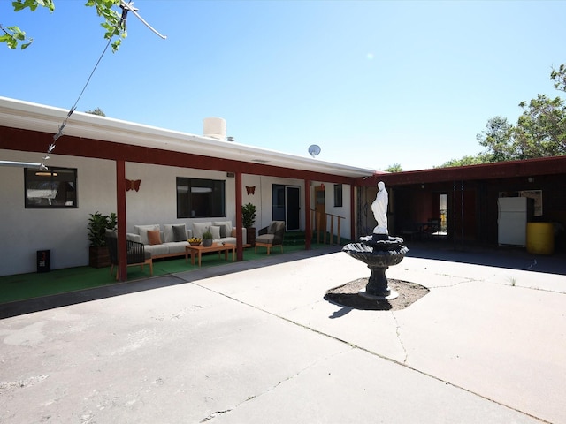 707 Middle San Pedro Rd, Espanola, NM 87532 - back of house featuring an outdoor living space, a patio, and stucco siding