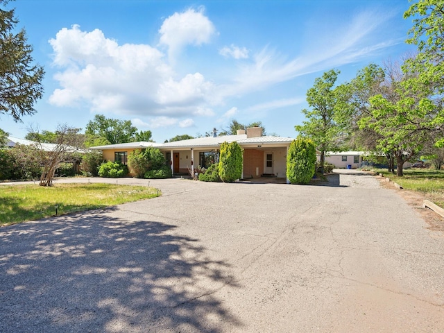 707 Middle San Pedro Rd, Espanola, NM 87532 - single story home featuring driveway and a chimney