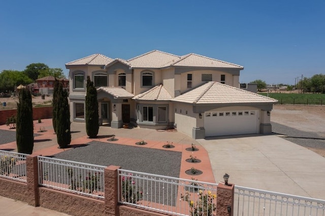 1521 Lakeview Rd SW, Albuquerque, NM 87105 - mediterranean / spanish home featuring stucco siding, a tile roof, a garage, and concrete driveway