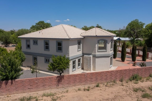 1521 Lakeview Rd SW, Albuquerque, NM 87105 - rear view of house with stucco siding and a tiled roof