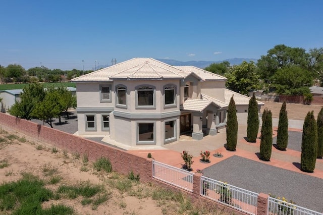 1521 Lakeview Rd SW, Albuquerque, NM 87105 - rear view of property featuring a fenced backyard, stucco siding, a patio, and a tile roof