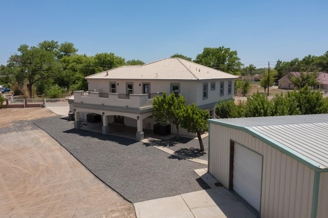 1521 Lakeview Rd SW, Albuquerque, NM 87105 - rear view of property featuring a balcony, an outdoor structure, and metal roof