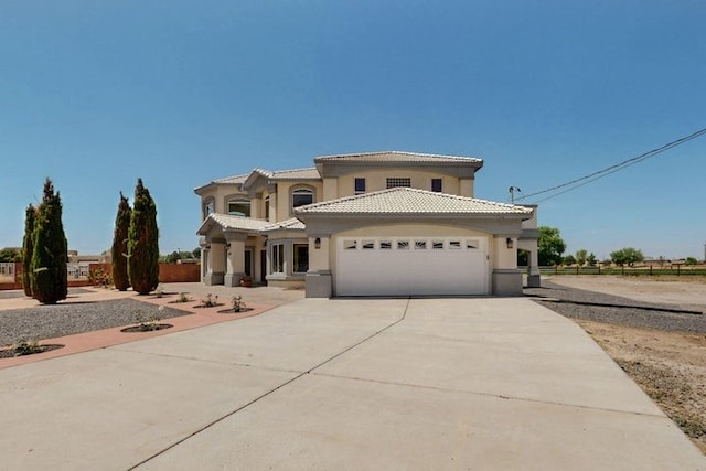 1521 Lakeview Rd SW, Albuquerque, NM 87105 - mediterranean / spanish-style home featuring driveway, an attached garage, stucco siding, and a tiled roof