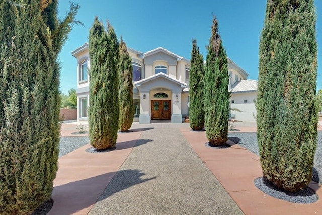 1521 Lakeview Rd SW, Albuquerque, NM 87105 - view of property hidden behind natural elements featuring french doors and stucco siding