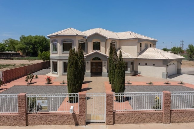1521 Lakeview Rd SW, Albuquerque, NM 87105 - mediterranean / spanish home with stucco siding, a fenced front yard, an attached garage, french doors, and concrete driveway