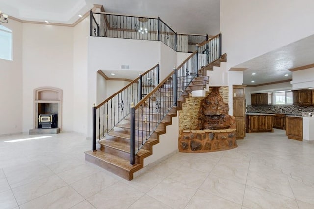 1521 Lakeview Rd SW, Albuquerque, NM 87105 - staircase featuring a high ceiling, ornamental molding, and recessed lighting