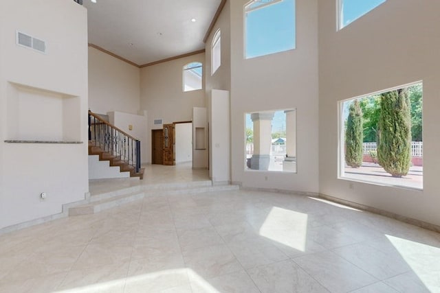 1521 Lakeview Rd SW, Albuquerque, NM 87105 - entryway with a high ceiling, stairs, plenty of natural light, crown molding, and baseboards