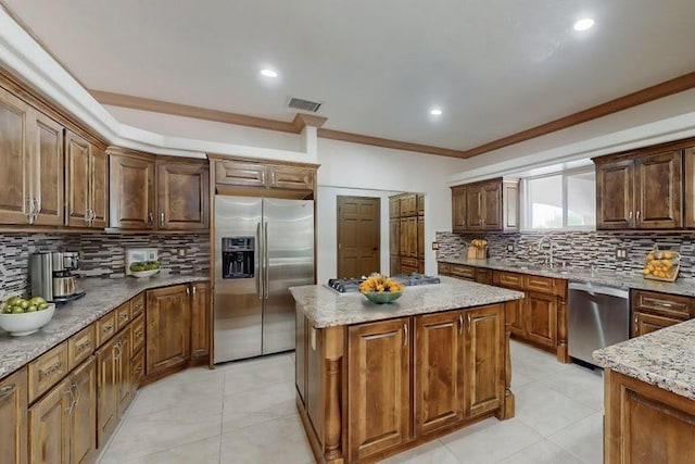 1521 Lakeview Rd SW, Albuquerque, NM 87105 - kitchen featuring stainless steel appliances, ornamental molding, decorative backsplash, light stone counters, and light tile patterned flooring