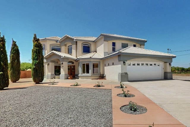 1521 Lakeview Rd SW, Albuquerque, NM 87105 - mediterranean / spanish home with a tiled roof, stucco siding, an attached garage, and driveway