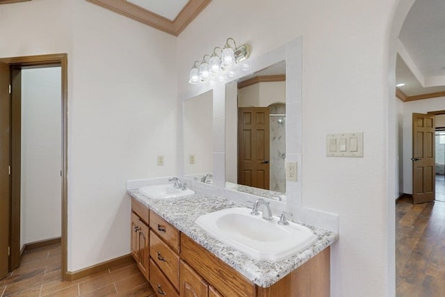 1521 Lakeview Rd SW, Albuquerque, NM 87105 - bathroom featuring crown molding, double vanity, wood finished floors, baseboards, and a shower