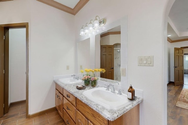 1521 Lakeview Rd SW, Albuquerque, NM 87105 - full bath with crown molding, double vanity, wood finished floors, a shower, and baseboards