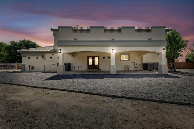 1521 Lakeview Rd SW, Albuquerque, NM 87105 - back of house at dusk with stucco siding and a patio
