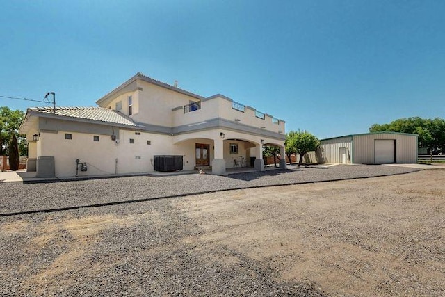 1521 Lakeview Rd SW, Albuquerque, NM 87105 - rear view of house with stucco siding, central air condition unit, and a garage