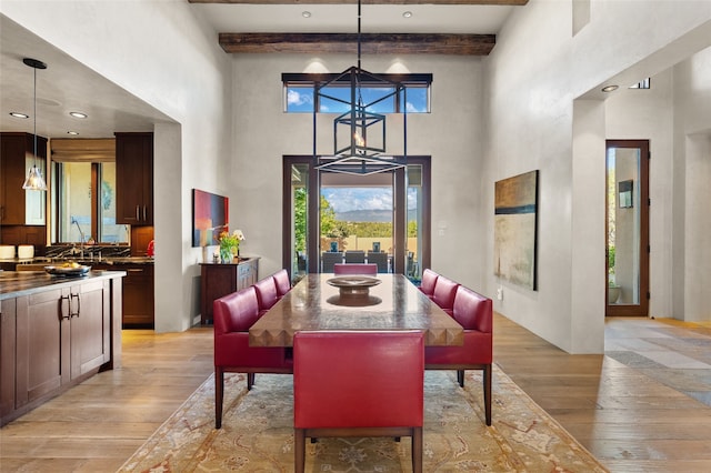 20 Rising Moon, Santa Fe, NM 87506 - dining area with a high ceiling, light wood-style floors, and beamed ceiling