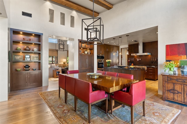 20 Rising Moon, Santa Fe, NM 87506 - dining space featuring a towering ceiling, light wood-style floors, and beam ceiling