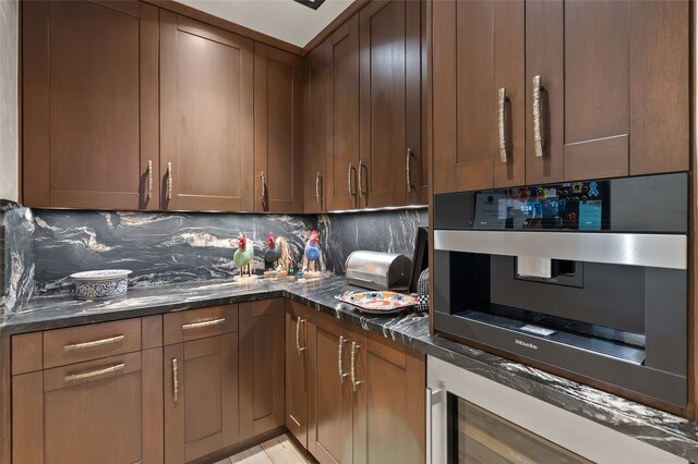 20 Rising Moon, Santa Fe, NM 87506 - kitchen with tasteful backsplash, dark stone countertops, wall oven, and wine cooler