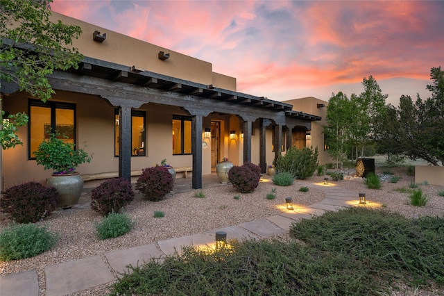 20 Rising Moon, Santa Fe, NM 87506 - view of front of home featuring covered porch and stucco siding