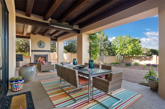20 Rising Moon, Santa Fe, NM 87506 - fenced backyard featuring a patio area, outdoor dining space, and an outdoor living space with a fireplace