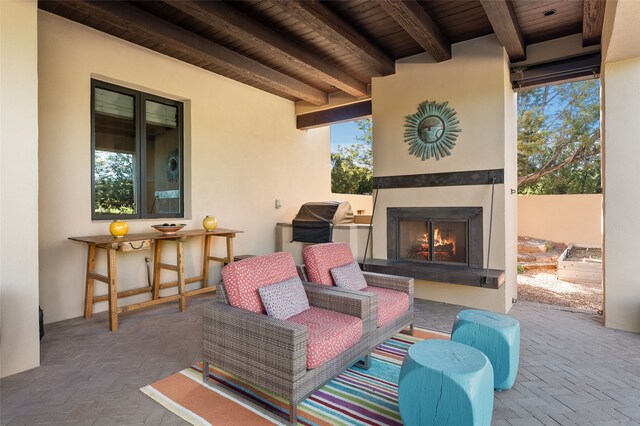 20 Rising Moon, Santa Fe, NM 87506 - view of patio / terrace featuring a lit fireplace