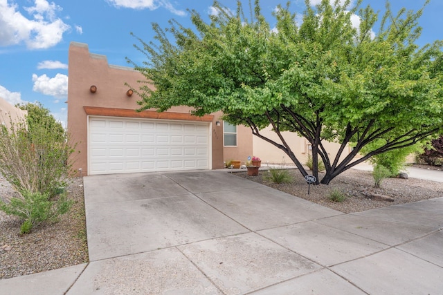 5910 Monte Rosa St, Santa Fe, NM 87507 - view of front of property featuring stucco siding and driveway