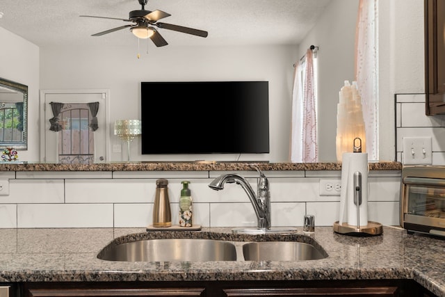 5910 Monte Rosa St, Santa Fe, NM 87507 - detailed view of a sink, ceiling fan, a textured ceiling, and dark stone countertops
