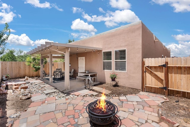 5910 Monte Rosa St, Santa Fe, NM 87507 - fenced backyard featuring an outdoor fire pit, a gate, and a patio area