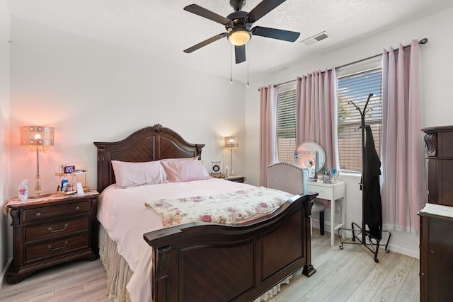 5910 Monte Rosa St, Santa Fe, NM 87507 - bedroom with light wood finished floors, a textured ceiling, a ceiling fan, and baseboards