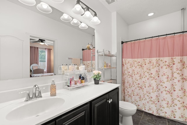 5910 Monte Rosa St, Santa Fe, NM 87507 - full bath featuring toilet, vanity, tile patterned flooring, curtained shower, and a ceiling fan