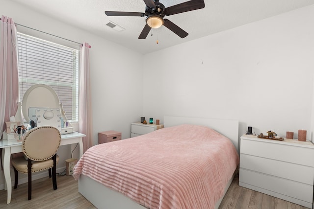 5910 Monte Rosa St, Santa Fe, NM 87507 - bedroom with light wood-style flooring, multiple windows, and ceiling fan