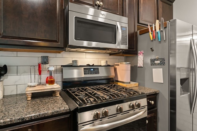 5910 Monte Rosa St, Santa Fe, NM 87507 - kitchen with stainless steel appliances, backsplash, dark brown cabinets, and dark stone countertops