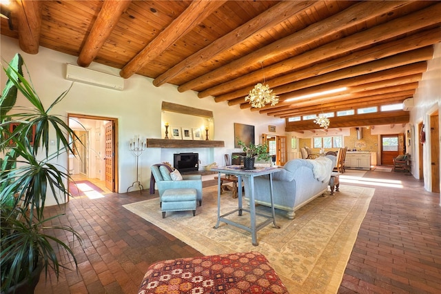 559 Camino Del Monte Sol, Santa Fe, NM 87505 - living area featuring brick floors, wooden ceiling with exposed beams, a wall mounted air conditioner, a glass covered fireplace, and a wall mounted AC