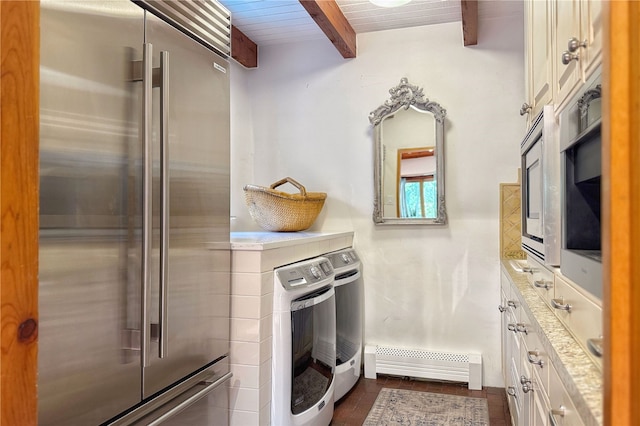 559 Camino Del Monte Sol, Santa Fe, NM 87505 - kitchen featuring high end refrigerator, baseboard heating, beamed ceiling, washing machine and dryer, and white cabinetry