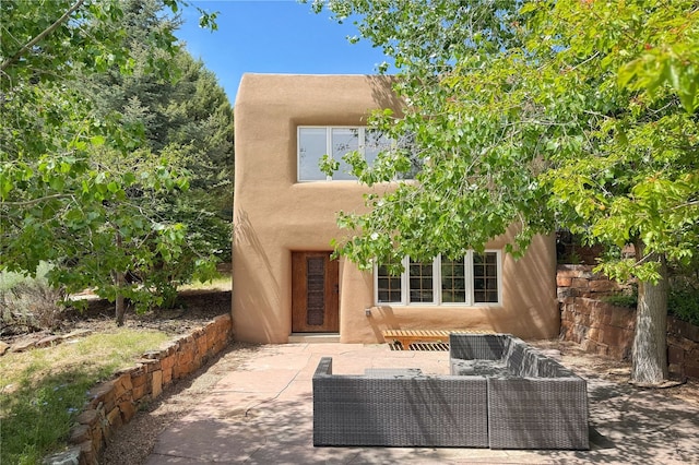 559 Camino Del Monte Sol, Santa Fe, NM 87505 - back of house with outdoor lounge area, a patio area, and stucco siding