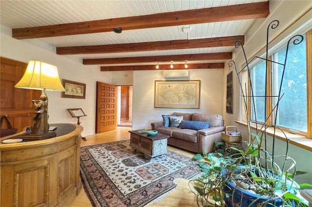 559 Camino Del Monte Sol, Santa Fe, NM 87505 - living area with a wall unit AC, plenty of natural light, wooden ceiling with exposed beams, and light wood-type flooring