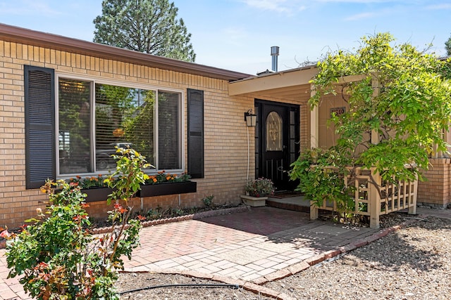 349 Garver Ln, White Rock, NM 87547 - property entrance featuring brick siding and a patio area