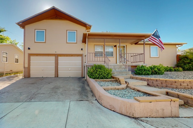 1765 38th St, Los Alamos, NM 87544 - view of front of house with an attached garage, driveway, and a porch